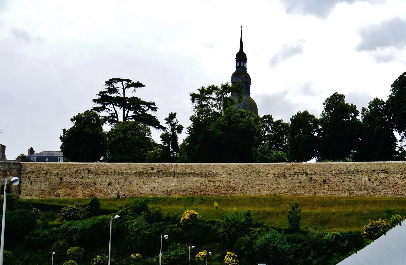 A stretch of Dinan's ramparts above a wooded bank
