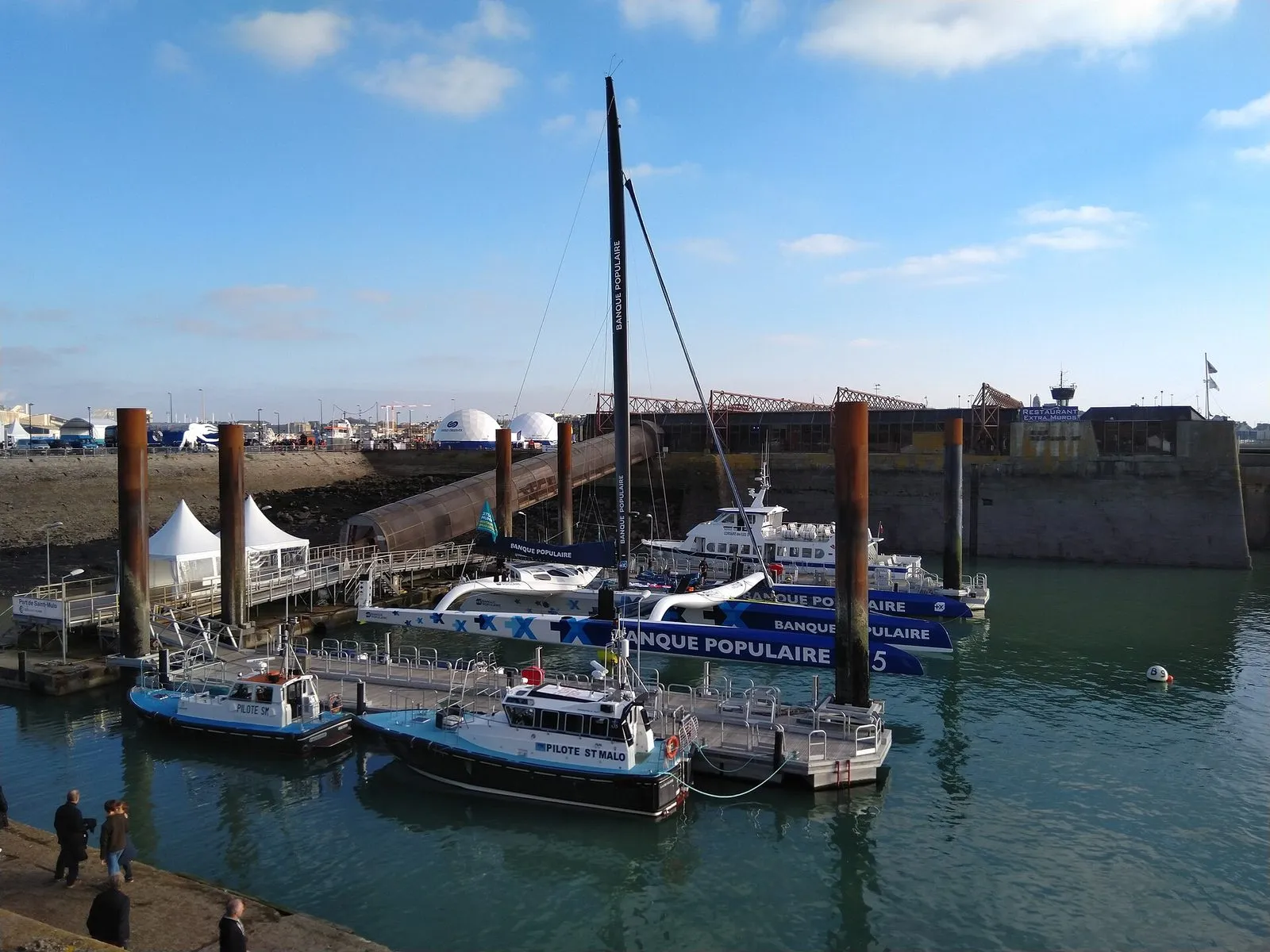 A maxi Ultim trimaran moored at Saint-Malo before the Route du Rhum