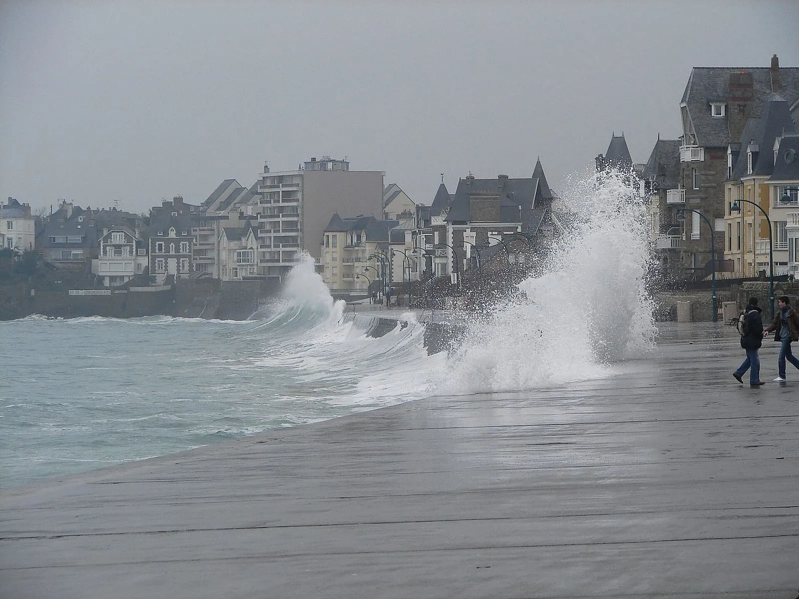 Sheets of seawater sweeping the Sillon seafront in winter