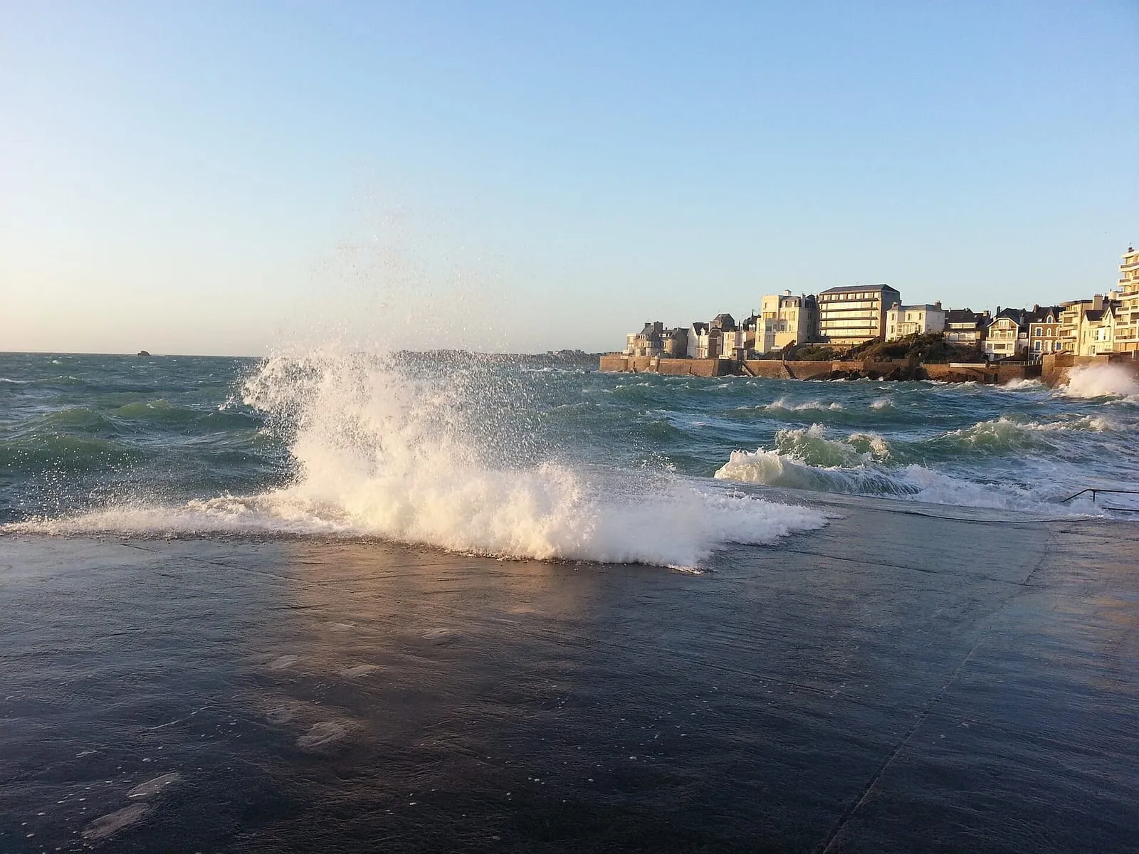 A wave bursting over the Rochebonne slipway in Saint-Malo
